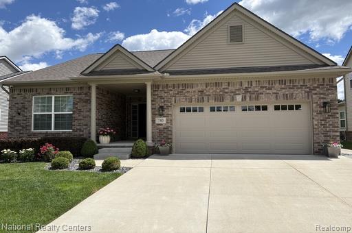 740 North Mill Street South Lyon, MI 48178 - Photo 2 of 56 Brick and siding exterior featuring a covered front entry