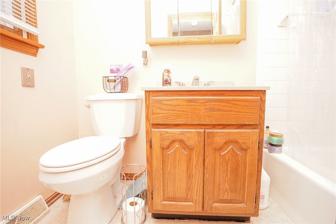 8651 King Graves Road Northeast Warren, OH 44484 - Photo 19 of 24 Full bathroom with tile patterned flooring, vanity, toilet, and bathtub / shower combination