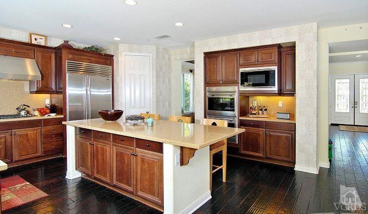 1373 Hidden Ranch Drive Simi Valley, CA 93063 - Photo 18 of 50 a kitchen with stainless steel appliances a stove and wooden floor