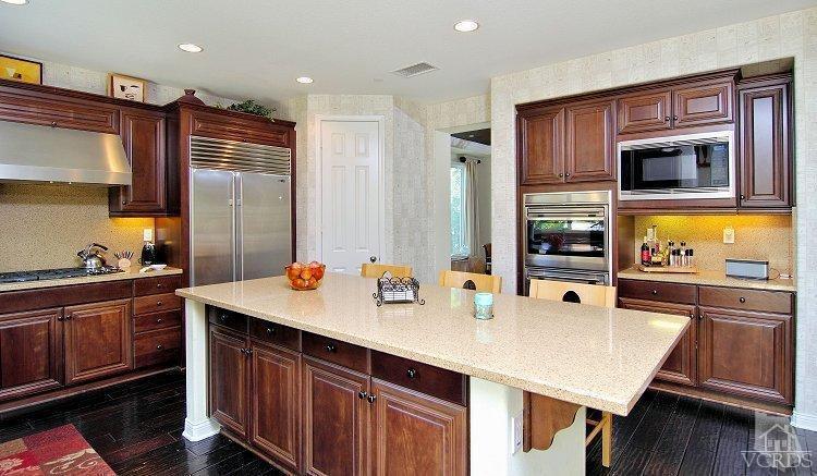 1373 Hidden Ranch Drive Simi Valley, CA 93063 - Photo 19 of 50 a kitchen with stainless steel appliances a sink counter space and cabinets