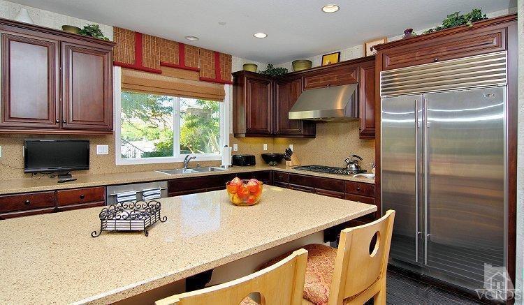 1373 Hidden Ranch Drive Simi Valley, CA 93063 - Photo 20 of 50 a kitchen with a refrigerator and a stove top oven