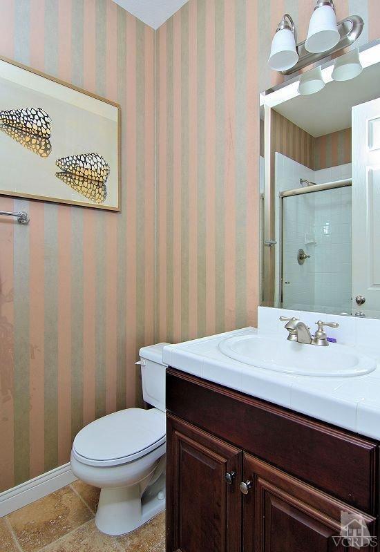 1373 Hidden Ranch Drive Simi Valley, CA 93063 - Photo 25 of 50 a bathroom with a sink a toilet and a mirror