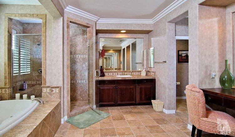 1373 Hidden Ranch Drive Simi Valley, CA 93063 - Photo 38 of 50 a bathroom with a tub a sink and a large mirror