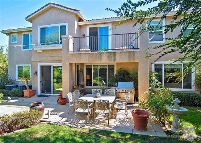 1373 Hidden Ranch Drive Simi Valley, CA 93063 - Photo 7 of 50 a view of a patio with table and chairs potted plants and large tree