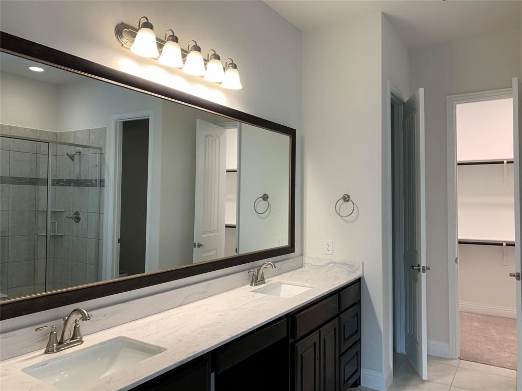 822 Susan Street Anna, TX 75409 - Photo 10 of 20 a bathroom with a sink and a mirror