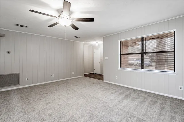 a view of a room with wooden floor closet and windows