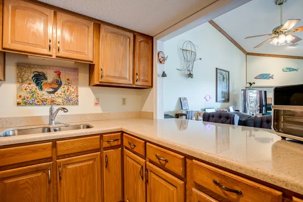 a kitchen with stainless steel appliances granite countertop a sink and cabinets