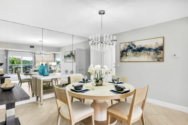 a view of a dining room with furniture a chandelier and wooden floor