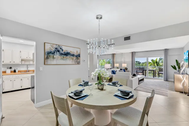 a dining room with furniture a livingroom and chandelier