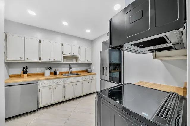 a kitchen with refrigerator and cabinets