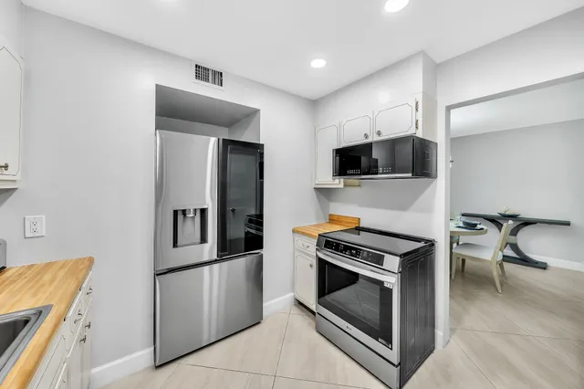 a kitchen with granite countertop a stove and a refrigerator