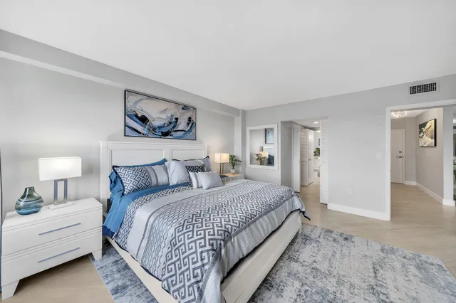 a bedroom with a bed and a painting