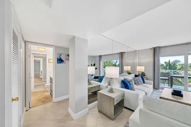 a living room with fireplace furniture and a large window