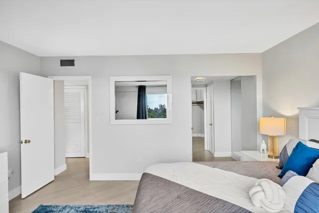 a bedroom with a bed and a lamp