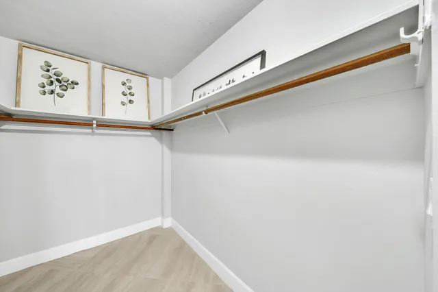 a view of a hallway with paintings on the wall