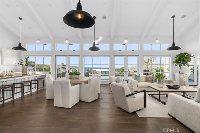 a bedroom with a large bed and a potted plant