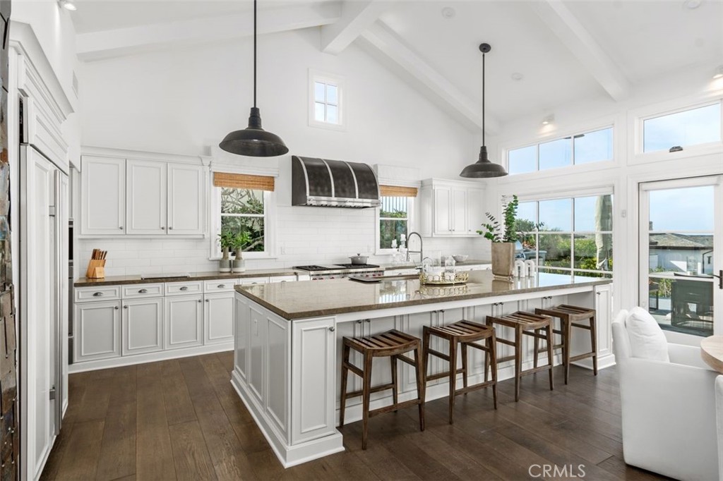 19 Seabreeze Terrace Dana Point, CA 92629 - Photo 14 of 40 a kitchen with stainless steel appliances granite countertop a stove and chairs