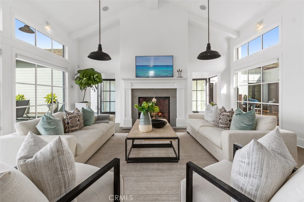 19 Seabreeze Terrace Dana Point, CA 92629 - Photo 10 of 40 a living room with furniture fireplace and a chandelier