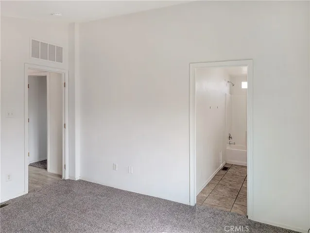 a view of an empty room with a bathroom