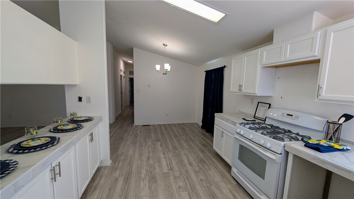 17647 Palowalla Road Blythe, CA 92225 - Photo 4 of 23 a kitchen with a stove a sink and a refrigerator