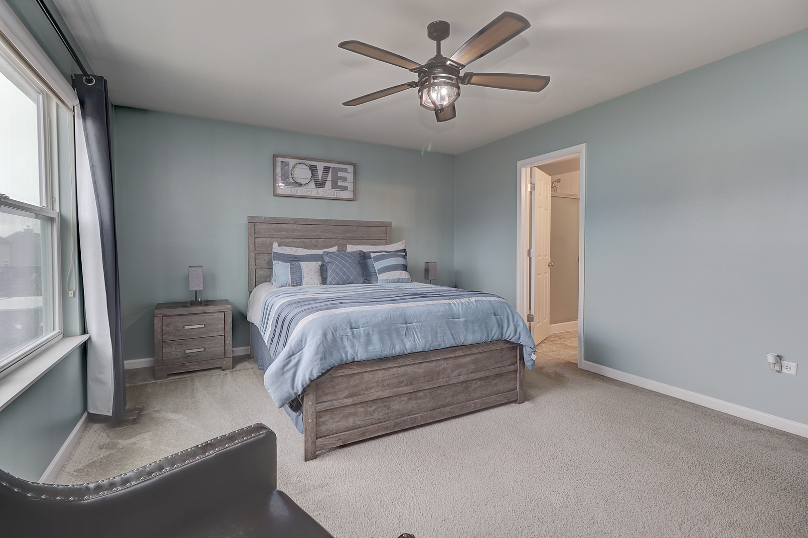 1809 Wesley Court Joliet, IL 60431 - Photo 13 of 29 a bedroom with a bed and a chandelier