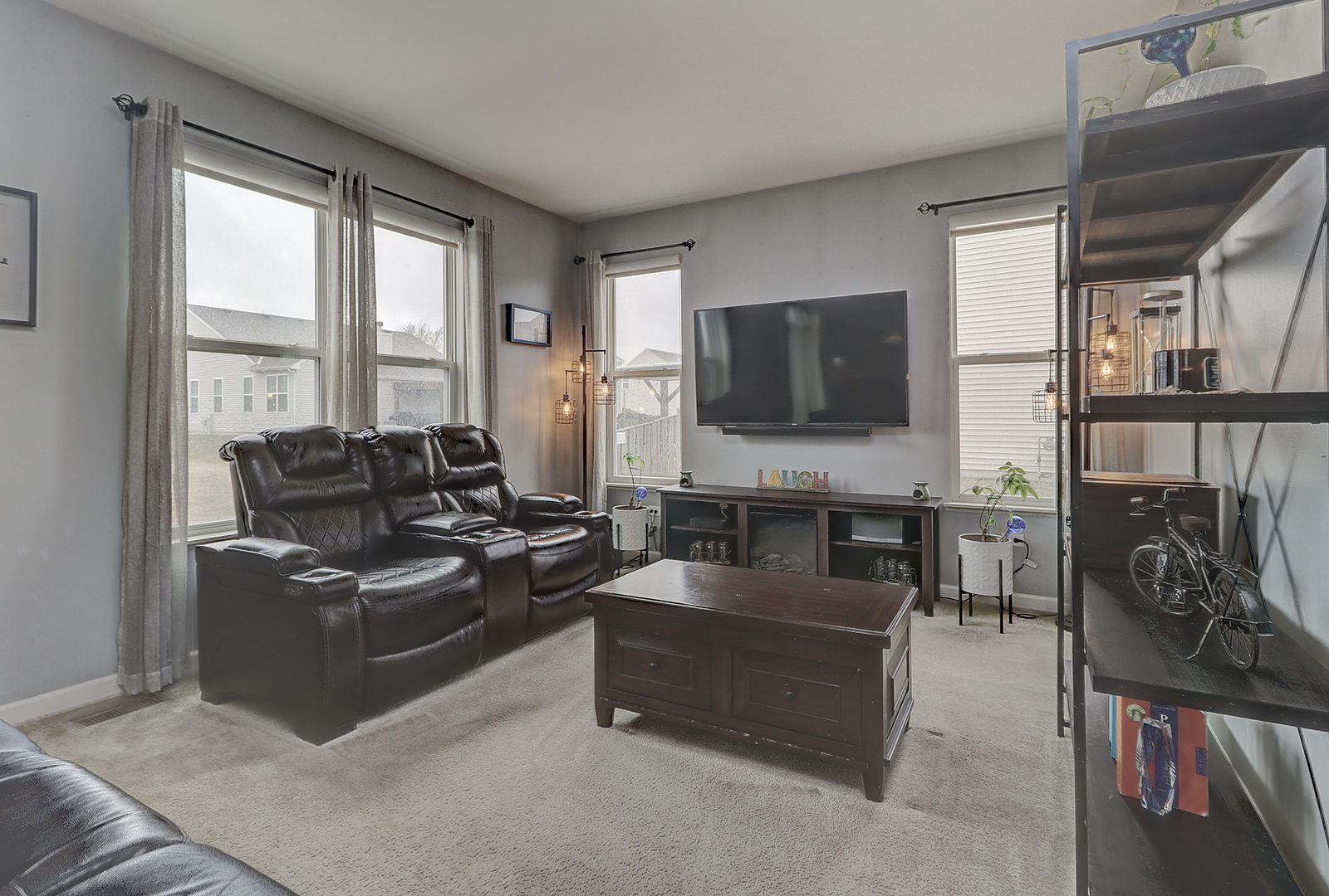 1809 Wesley Court Joliet, IL 60431 - Photo 9 of 29 a living room with furniture a flat screen tv and a large window