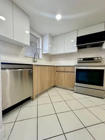 a kitchen with stainless steel appliances granite countertop a refrigerator a stove a microwave and a sink