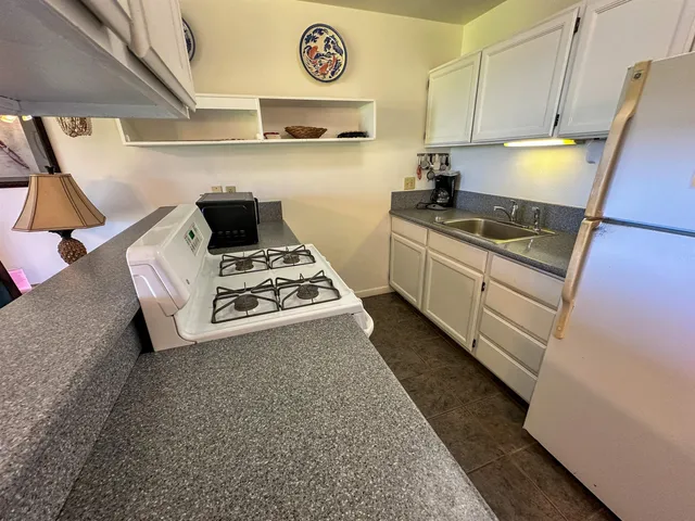 a kitchen with a stove a sink and a refrigerator