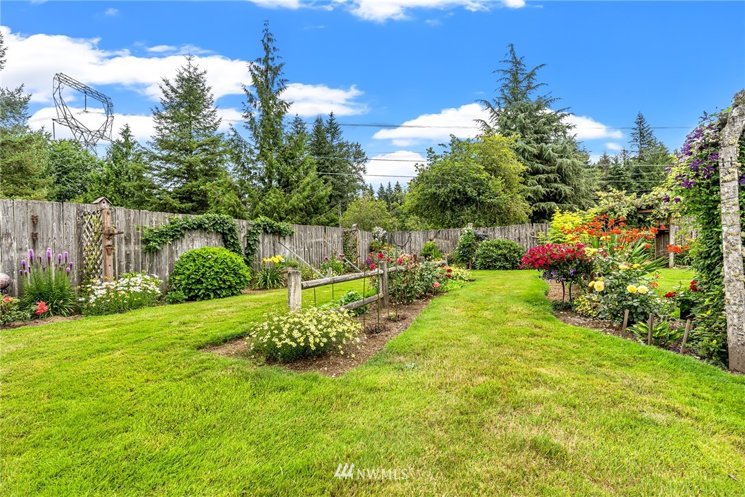 25431 Cromwell Road Monroe, WA 98272 - Photo 30 of 40 a view of a garden with a building in the background