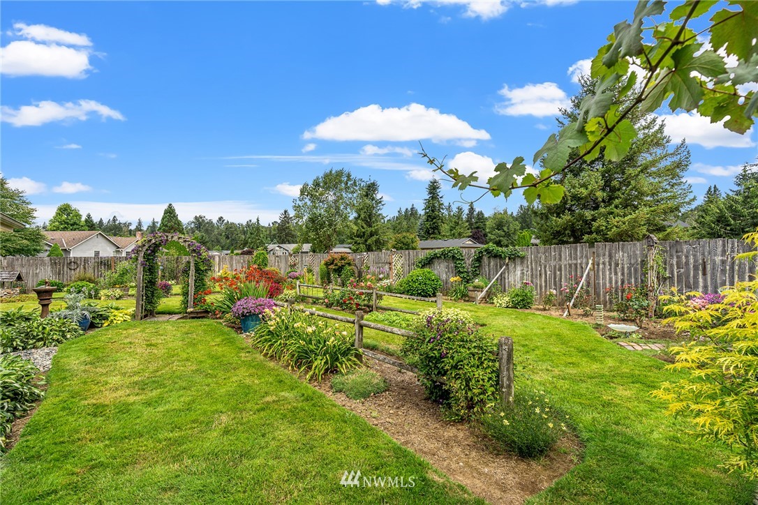25431 Cromwell Road Monroe, WA 98272 - Photo 31 of 40 a view of a garden with a house in the background