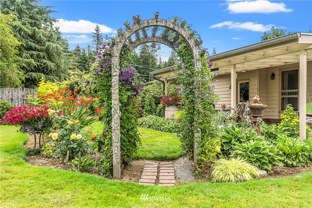 25431 Cromwell Road Monroe, WA 98272 - Photo 32 of 40 a view of a pathway of a house with a big yard and potted plants
