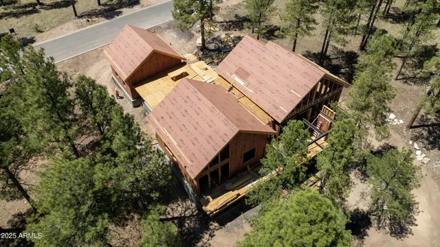 an aerial view of a house with a yard and trees
