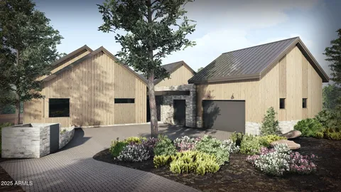 a front view of a house with a yard with potted plants