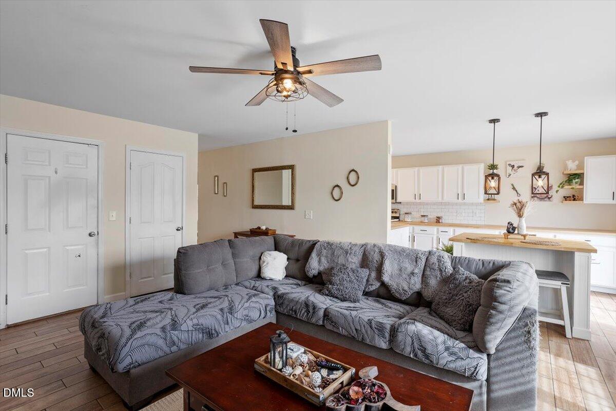 205 Battery Way Bunnlevel, NC 28323 - Photo 12 of 37 a living room with furniture and a chandelier