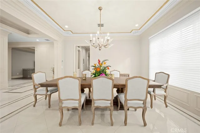 a view of a dining room with furniture and chandelier