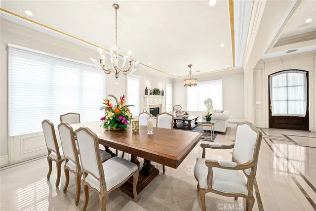 a view of a dining room with furniture and a chandelier