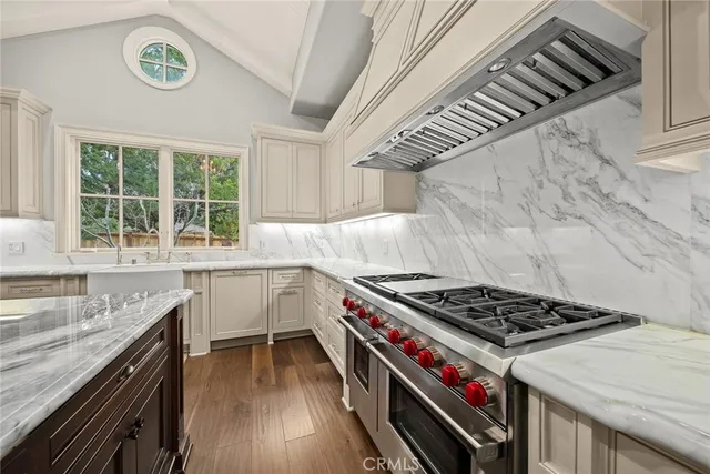a kitchen with granite countertop a stove and a sink