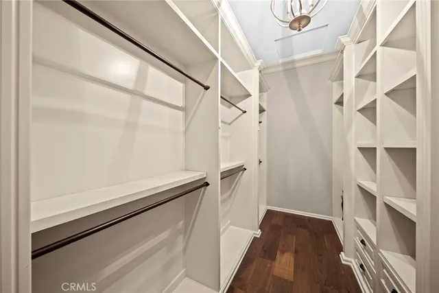 a view of walk in closet with empty racks