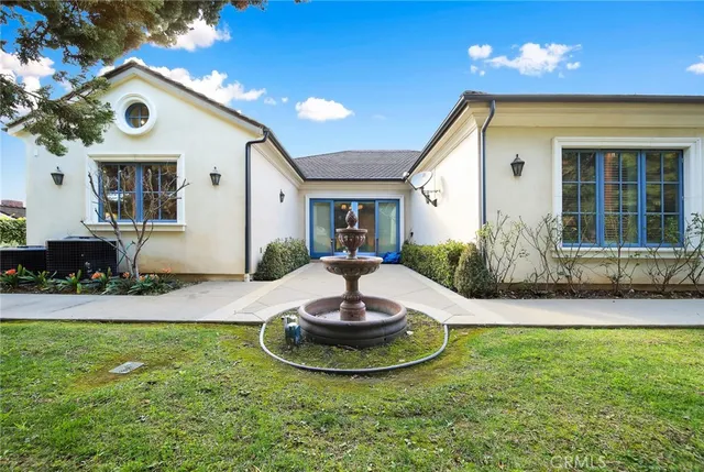 a view of a house with patio and a yard