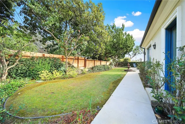 a view of a garden with a fountain in the back yard