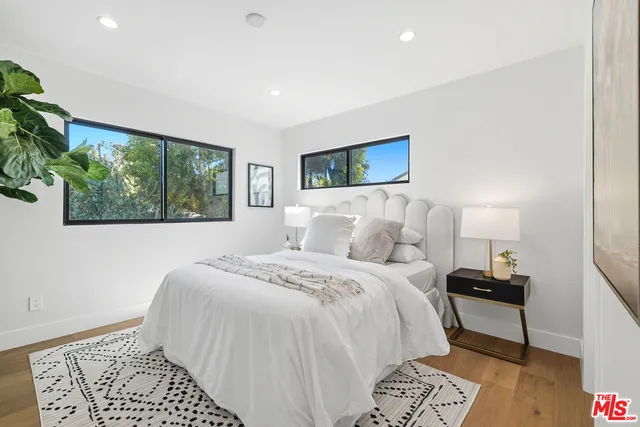 a bedroom with a large bed and a window