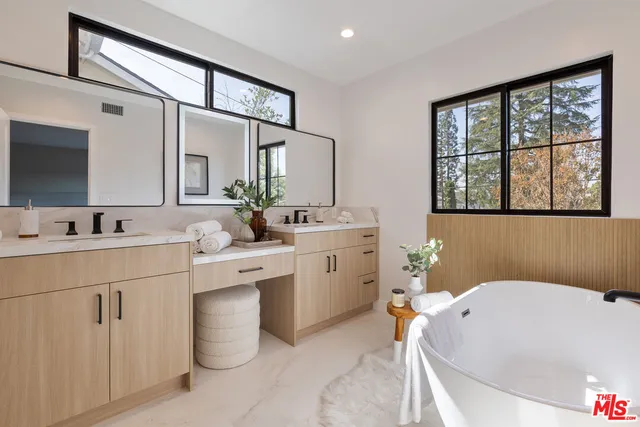 a bathroom with a sink mirror and a bathtub