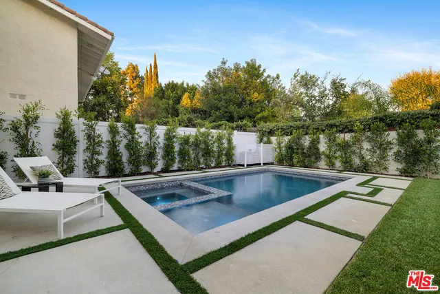 a swimming pool with outdoor seating and yard