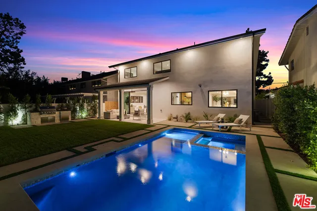 a front view of a house with swimming pool yard and outdoor seating
