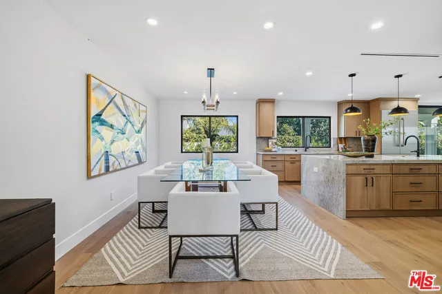 a living room with furniture a rug and a large window