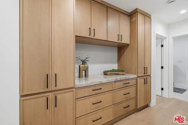 a kitchen with stainless steel appliances granite countertop a refrigerator and cabinets