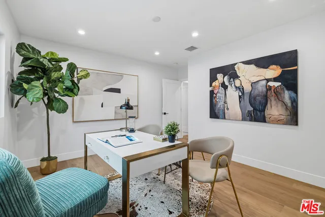 a view of a livingroom with furniture and a potted plant