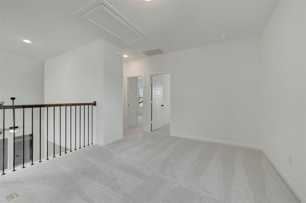 1908 Cola Drive Van Alstyne, TX 75495 - Photo 28 of 29 Open loft area featuring light gray carpeting and recessed lighting
