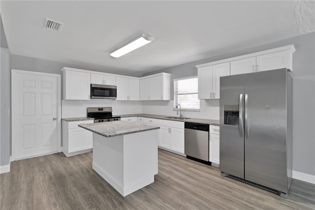 462 Watercrest Street Sebastian, FL 32958 - Photo 11 of 36 a kitchen with a refrigerator stove and microwave