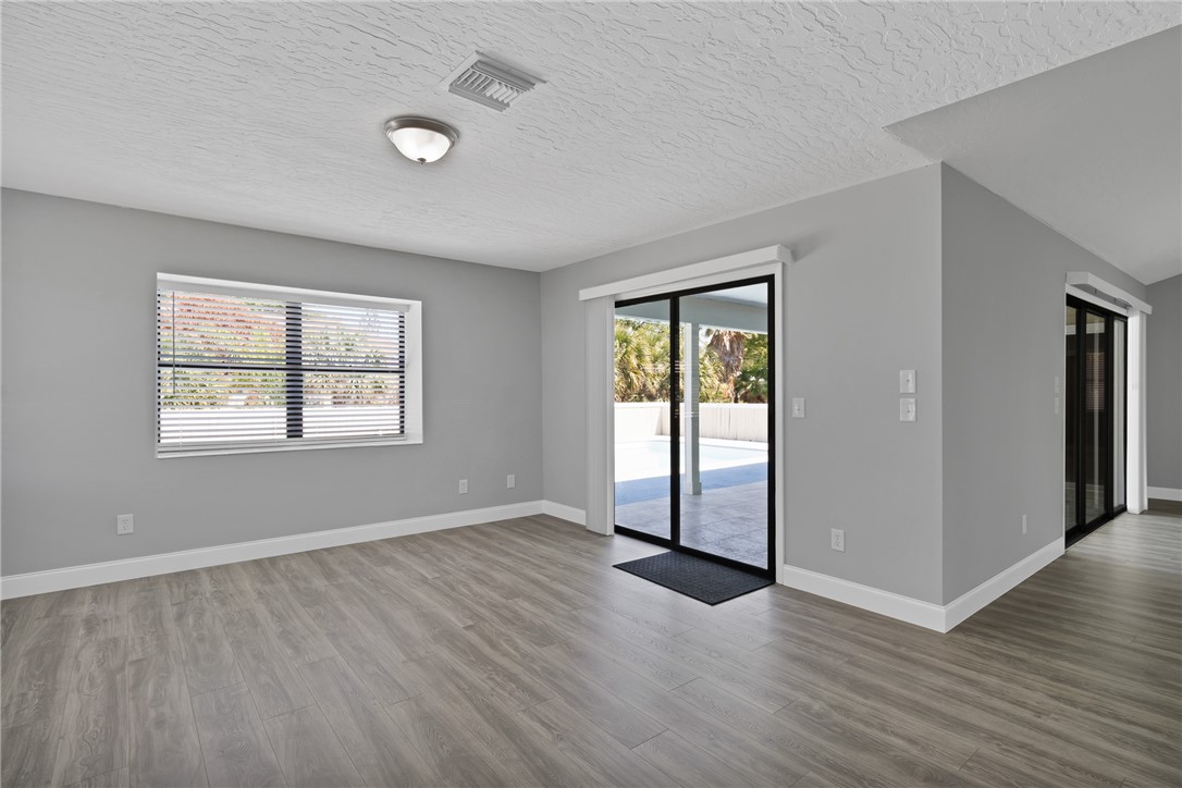 462 Watercrest Street Sebastian, FL 32958 - Photo 14 of 36 an empty room with wooden floor and windows
